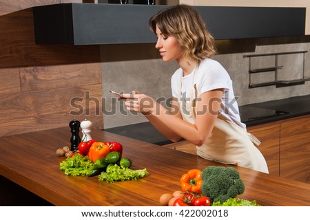 Young and beautiful housewife woman making picture on her cellph
