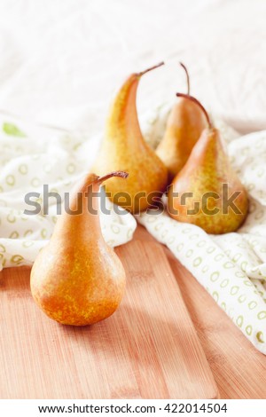 Fresh ripe organic pears on a rustic wooden table, selective focus close up