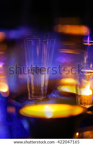 Blurred candlelit champagne glasses. Alcoholism, intoxication, double vision, drunkenness, high class party debauchery concept. 