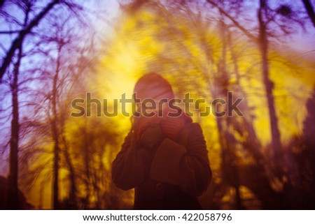 young creative girl doing a photo shoot outdoors in winter