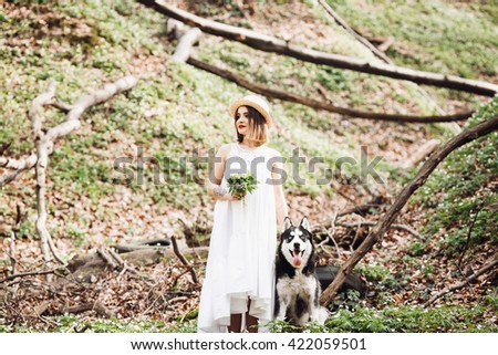 Girl and her dog  actively spend time in wood