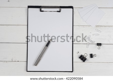 Business blank, notepad and pen at office desk table top view. Corporate stationery branding mock-up.  Copy space for text.