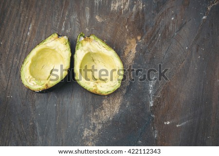 Blurry and soft image of slice sweet Avocado on the top of old wooden in natural light. Selective focus for shallow depth of field with classic tone with added some noise.