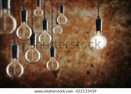 Idea and leadership concept - Vintage  bulbs on the grunge background