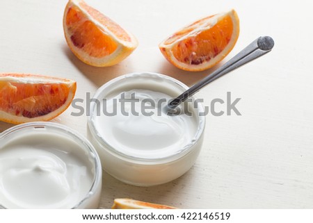 Yogurts or cosmetic cream assortment  in glass jar on ligth background. Natural, healthy, gourmet dessert for granola breakfast. Sweet yoghurts closeup with copy space.