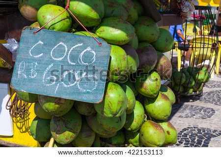 Bunch of fresh coco verde (green coconuts) hanging at Ipanema beach sidedwalk in Rio de Janeiro, Brazil