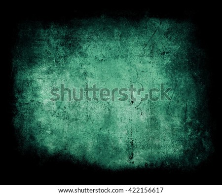 Beautiful green abstract vintage grunge background with faded central area for your text or picture, scratched scary background with frame