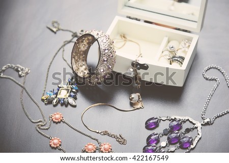 A collection of vintage jewelry in antique wooden jewelry box Royalty-Free Stock Photo #422167549