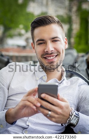 Portrait of smiling man with smartphone 