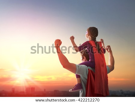 Happy loving family. Father and his daughter child girl playing outdoors. Daddy and his child girl in an Superhero's costumes. Concept of Father's day. Royalty-Free Stock Photo #422212270
