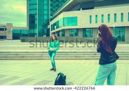 women tourists walk on new city with a backpack and take photos for memory