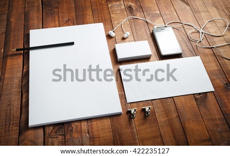 Photo of blank stationery and corporate identity template on vintage wooden background. Letterhead, business cards, envelope and pen. Blank brand template.