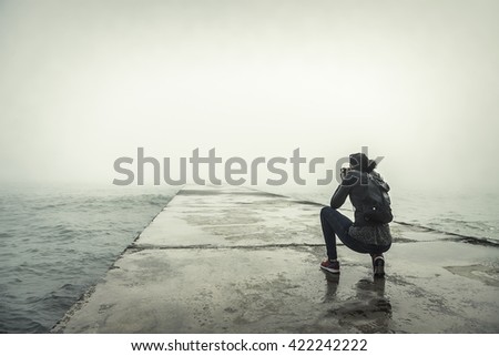 Photographer on a misty pier. Vintage photo.
