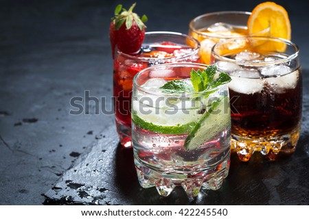assortment of iced fruit drinks on a dark background, horizontal Royalty-Free Stock Photo #422245540