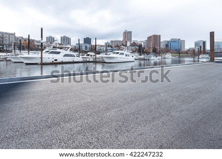 empty asphalt road near yacht with cityscape and skyline of portland