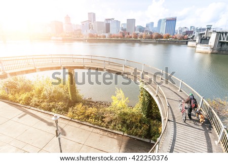 elevated bridge near water with cityscape and skyline of portland