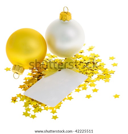 Two christmas balls on heap of confetti stars with white blank card