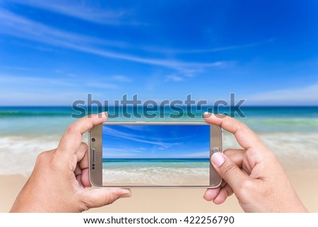 Close up hand of woman holding smartphone and take photo of view
