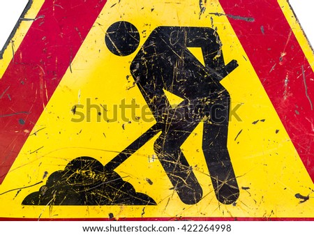 Close-up of men at work sign at a road construction site.