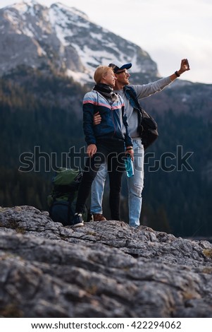 Young couple doing a selfie  while hiking.
