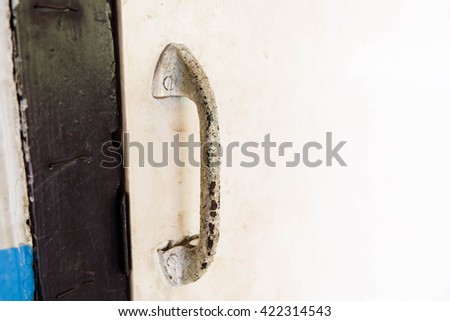 Old Metal door handle on old door.