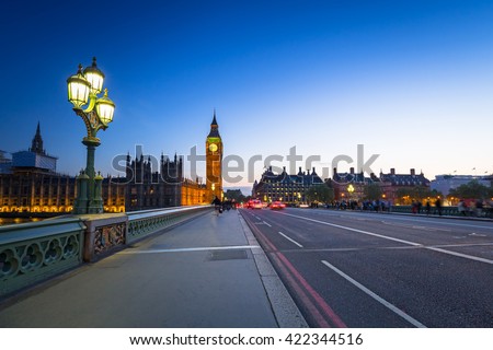 London scenery at Westminster bridge with Big Ben and blurred red bus, UK Royalty-Free Stock Photo #422344516