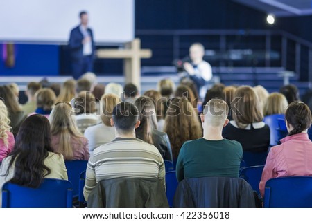 Business Conferences Concept and Ideas. Male Professional Lecturer Speaking In front of the Group of People. Horizontal Image Composition.