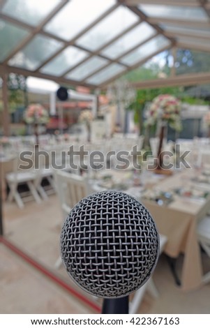 Restaurant.Restaurant ,decorated vith plates, cutlery, glasses, flowers, knives and various decoration materials.The view from stage ,behind the microphone.