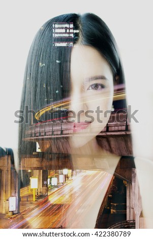 Double exposure of Asian woman dissolved with night cityscape.