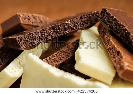 assortment porous chocolate close-up on a wooden background