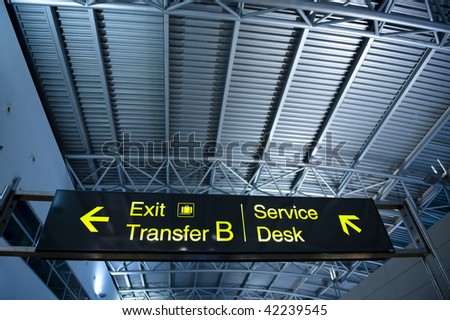 Exit and transer sign at modern airport