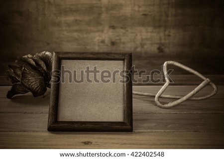Wooden frame and flower on wooden background,Still life of love