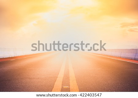 Empty asphalt road to sunset Royalty-Free Stock Photo #422403547