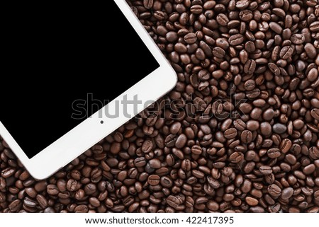 tablet computer on coffee beans background