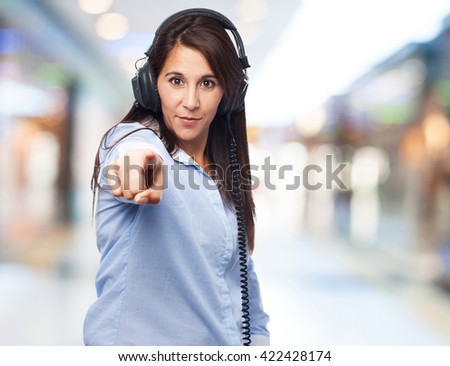 woman pointing front with headphones