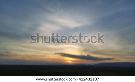 Blurred sky clouds and sun backgrounds. Blurred horizon. Blurry landscape as background. Beautiful sunset.