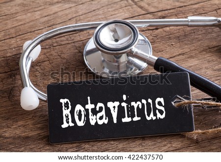 Stethoscope on wood with Rotavirus words as medical concept Royalty-Free Stock Photo #422437570