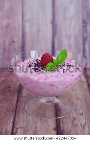 Raspberry mascarpone dessert with mint leaf and sweet basil seeds