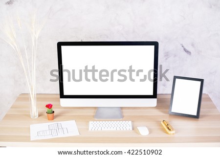 Creative designer desktop with blank white computer screen and picture frame, construction sketch, wheat spikes and other items. Mock up