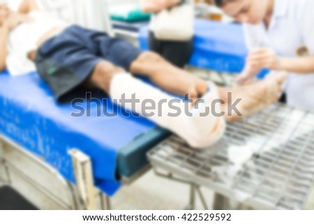 nurse splint cast on the leg patient in hospital , blur