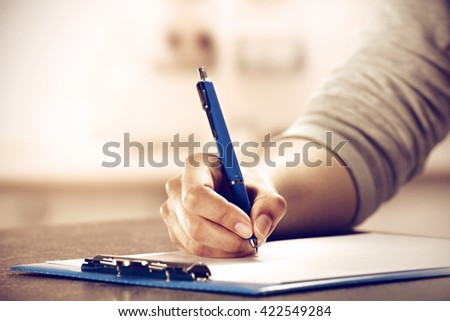 blue pen and hand and kitchen room and desk background 
