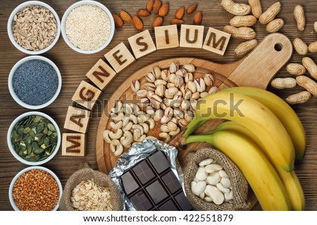 Products containing magnesium: bananas, pumpkin seeds, blue poppy seed, cashew nuts, beans, almonds, sunflower seeds, oatmeal, buckwheat, peanuts, pistachios, dark chocolate and sesame seeds Royalty-Free Stock Photo #422551879