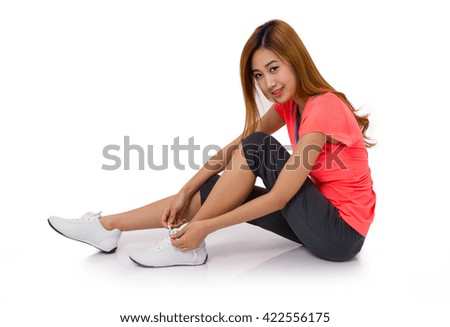 Asian young woman tying running shoes laces Isolated on white.