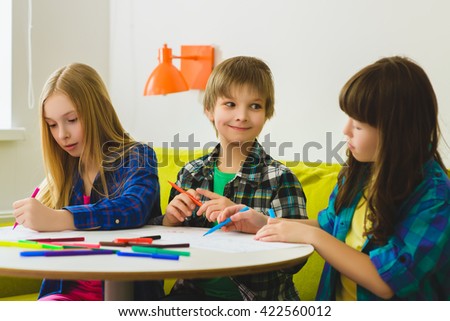 happy Little girls and boy drawing pictures. Indoor at room
