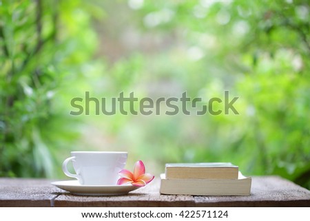 Notebook with pencil and cup on wooden table