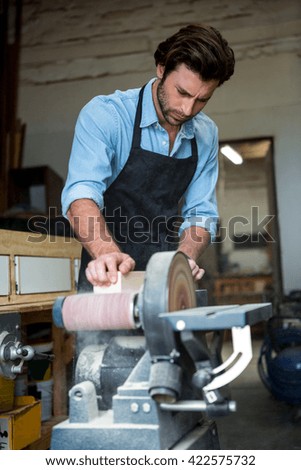 Carpenter working on his craft in a dusty workshop