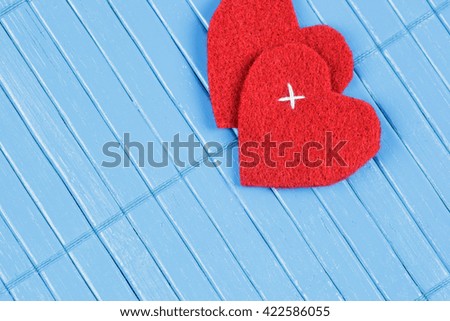 blue wooden background with red heart 