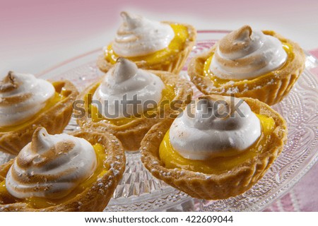 Excellent pastry with lemon cream and meringue on glass dish