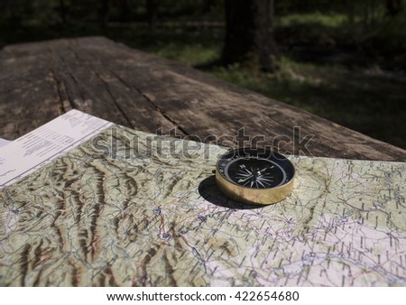 compass on the map/magnetic compass standing upright on a world map conceptual of global travel/the time-tested Navigator
