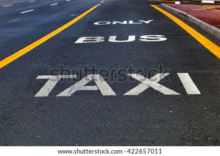 Bus and Taxi sign painted on street outdoors
